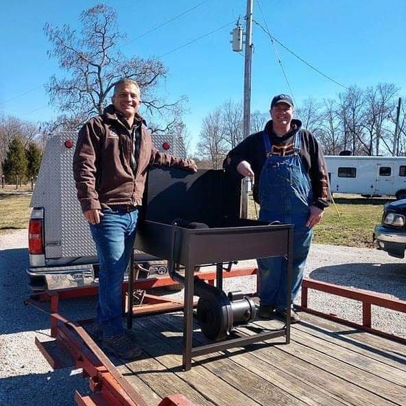 two men standing with forge